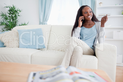 Woman with smartphone on sofa