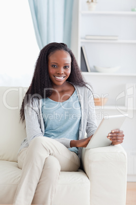 Close up of woman with tablet on sofa