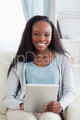 Close up of woman using tablet on sofa