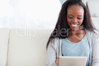 Close up of woman using her tablet on sofa