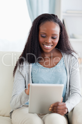 Close up of woman using her tablet on couch