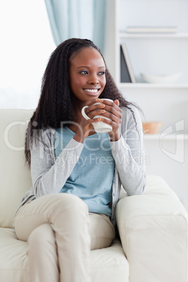 Woman on sofa with a cup