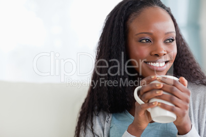 Close up of woman with a cup on sofa