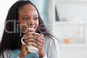 Close up of woman with a cup on couch