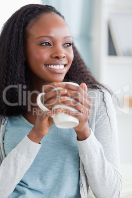 Close up of woman having a coffee on sofa