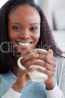 Close up of woman having coffee on couch