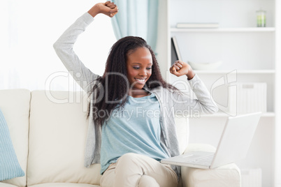 Woman cheering at laptop