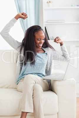 Woman cheering at her laptop