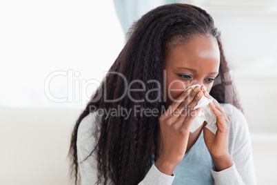 Close up of woman blowing her nose