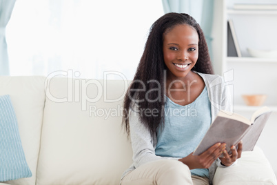 Woman reading a book on sofa