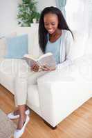 Woman on sofa reading a book