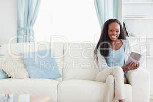 Woman on couch reading a book