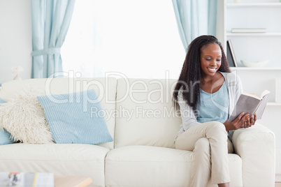 Woman reading a book in living room
