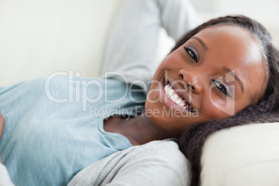 Close up of smiling woman taking a rest on the sofa