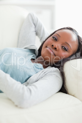 Close up of happy woman taking a rest on the sofa