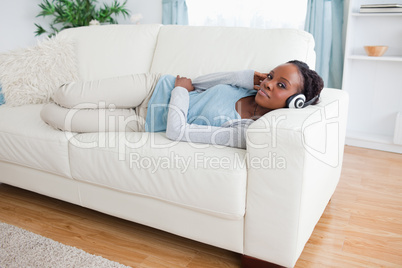 Woman on couch listening to music