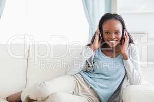 Woman relaxing on couch with headphones on