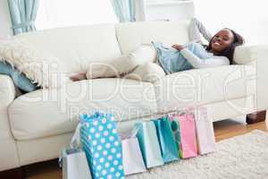 Woman lying on couch after shopping