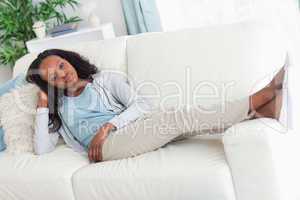Woman on sofa putting her feet up