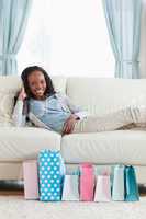 Woman relaxing on sofa after shopping