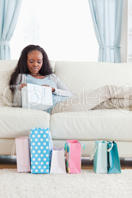 Woman on sofa checking her shopping