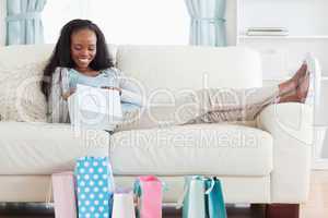 Woman on couch checking her shopping