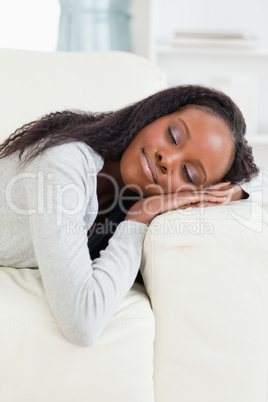 Woman lying on the sofa with eyes closed