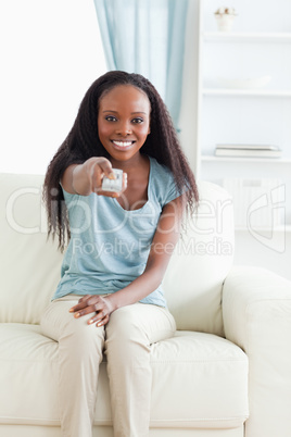 Woman on sofa with remote control
