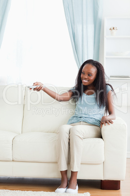 Woman in living room with remote