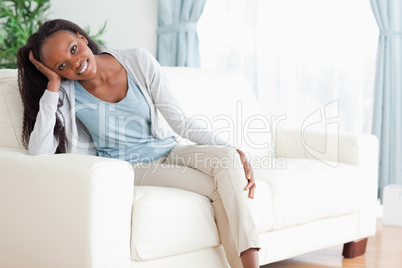 Woman enjoys sitting on the couch