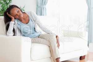 Woman on sofa in thoughts