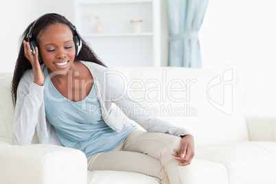 Woman with eyes closed listening to music