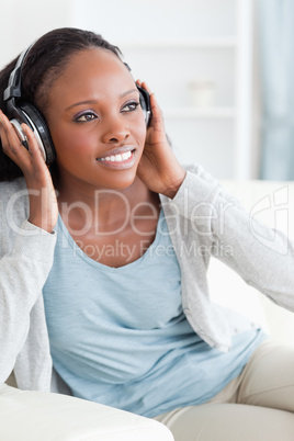 Close up of woman enjoying music on the couch Close up of woman enjoying music on the couch