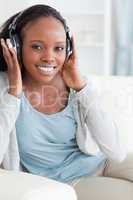 Close up of woman listening to music on sofa