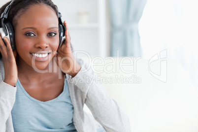 Close up of woman listening to music on couch