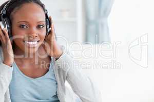 Close up of woman listening to music on couch