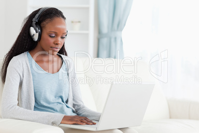 Woman with headphones on working on laptop