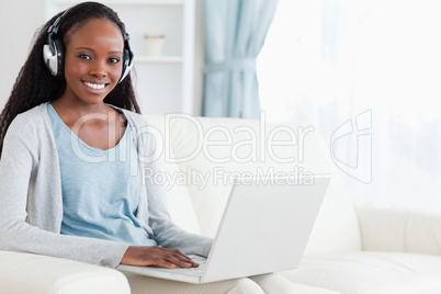 Woman with headphones on working on notebook