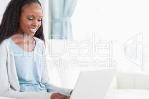 Young woman on sofa with laptop