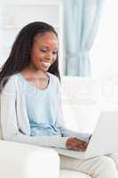 Woman on couch with notebook