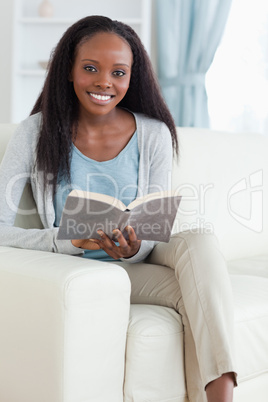 Woman with book on sofa