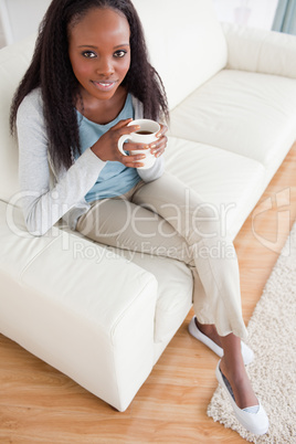 Woman enjoying coffee on sofa