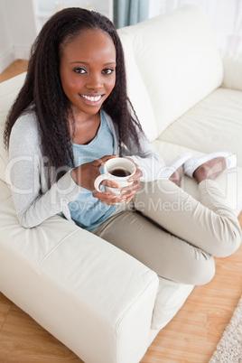 Woman enjoying coffee on couch