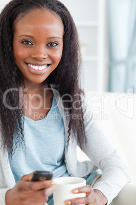 Close up of woman texting and having a coffee