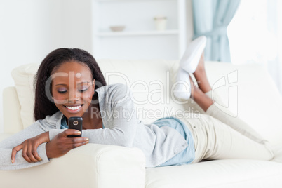 Woman texting on couch