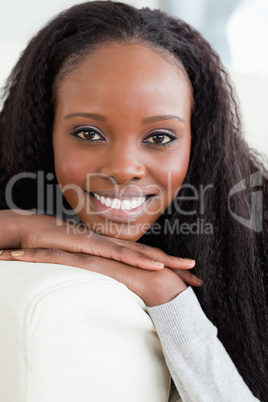 Close up of smiling woman lying on the sofa