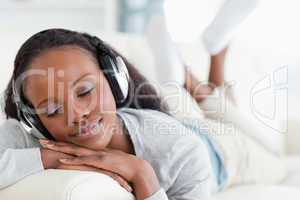Close up of woman enjoying music on sofa