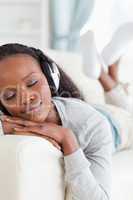 Close up of woman enjoying music on couch