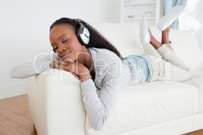 Woman relaxing with music on her sofa