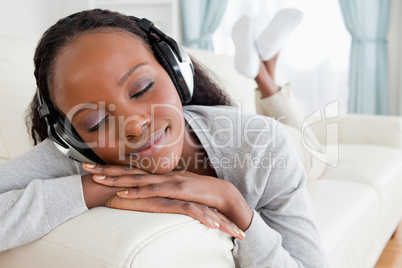 Close up of woman relaxing with music on her sofa